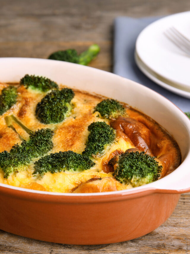 Tasty broccoli casserole in baking dish on wooden table